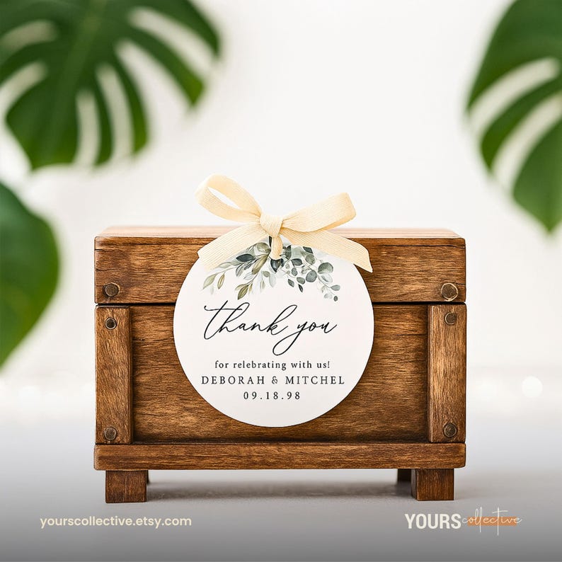May include: A small, stained wooden box with a decorative tag tied with a cream-colored ribbon. The tag reads "Thank you" with the names Deborah & Mitchel and the date 09.18.98. The tag has a floral design.