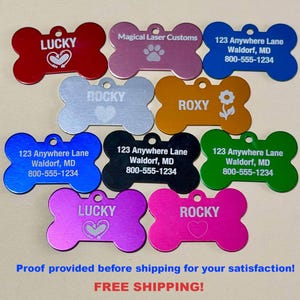 May include: A collection of colorful, bone-shaped pet tags. The tags are in various colors, including red, pink, blue, and green. Some tags have names like "LUCKY" and "ROXY", while others have contact information. The text "Magical Laser Customs" is also visible.