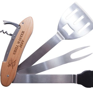 May include: A multi-tool grilling set with a wooden handle engraved with "GRILL MASTER JEFF". The set includes a corkscrew, spatula, fork, and basting brush. The tools are made of stainless steel.
