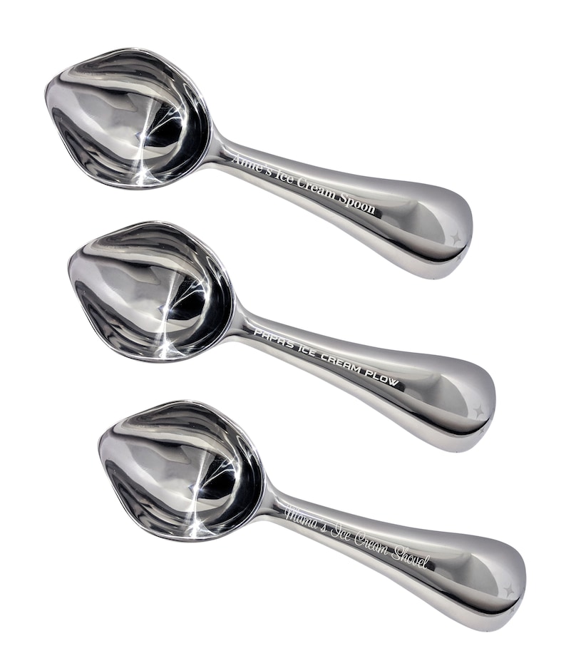 May include: Three silver ice cream scoops with personalized engravings. The scoops are arranged in a vertical stack, with the top scoop reading "Anne's Ice Cream Spoon", the middle scoop reading "Papas Ice Cream Plow", and the bottom scoop reading "Mama's Ice Cream Shovel".