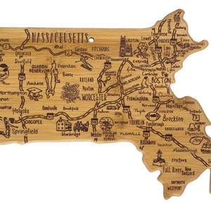 May include: A wooden chopping board shaped like the state of Massachusetts with the names of cities and towns engraved on it. The board is brown and has a natural wood grain.