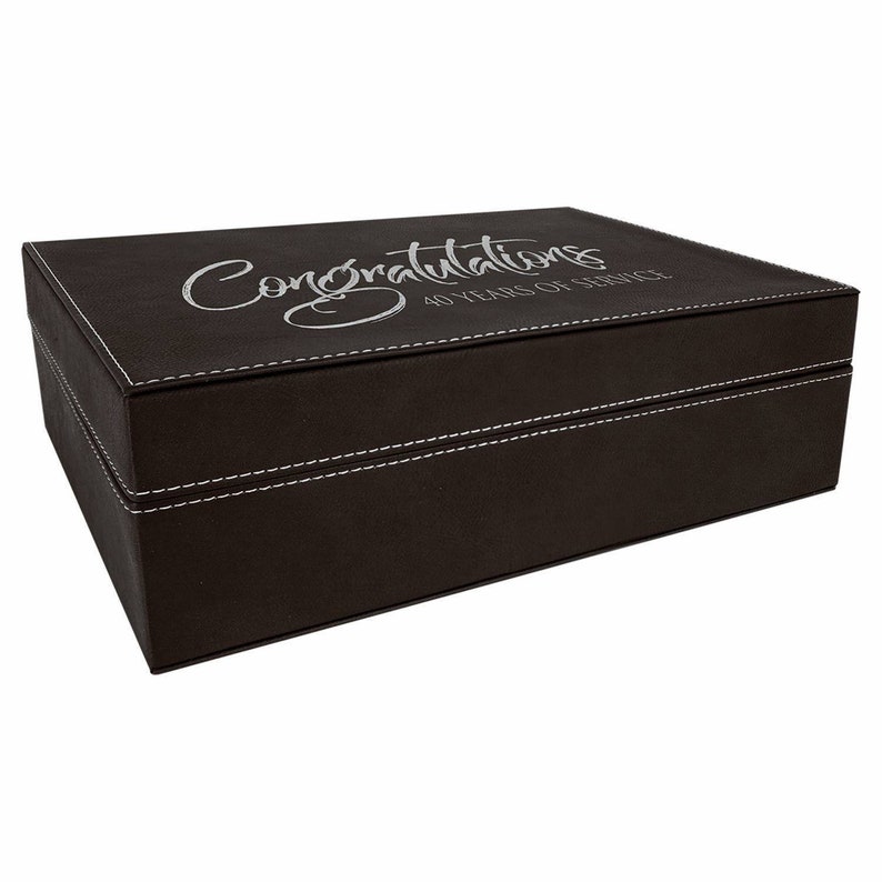 May include: A brown leatherette box with white stitching and the text "Congratulations 40 Years of Service" engraved on the top.