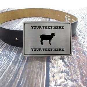 May include: Silver belt buckle with a black sheep silhouette and the text "YOUR TEXT HERE" on a black leather belt.