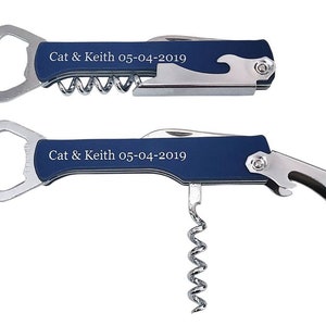 May include: A blue and silver multi-tool bottle opener with a corkscrew and a personalized inscription that reads "Cat & Keith 05-04-2019".