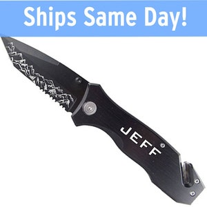 May include: Black pocket knife with a serrated blade and a safety feature. The knife has a mountain design on the blade and the name "JEFF" engraved on the handle.