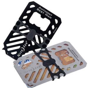 May include: Two black and silver Nite Ize multi-tools with the text "ANTHONY BEST MAN" and "JOSEPH GROOMSMAN" engraved on them. The tools have a variety of features, including a bottle opener, a ruler, and a card holder.