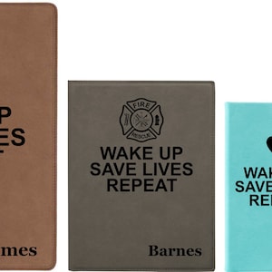 May include: Four different colored notebooks with the text "Wake Up Save Lives Repeat" and a different symbol on each. The notebooks are brown, gray, light blue, and dark blue. The symbols are a medical caduceus, a fire department symbol, a heart, and a medical caduceus. The notebooks are personalized with the names James, Barnes, Alicia, and Jane.