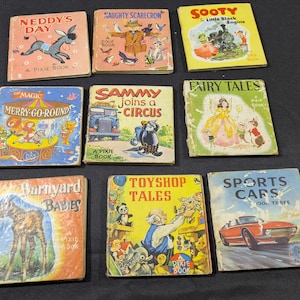 May include: A selection of vintage children's books, including titles such as "Neddy's Day," "Naughty Scarecrow," and "Sooty." The books feature colourful illustrations and are labelled as "Pixie Books." The covers display various themes.