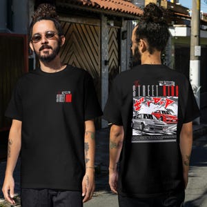 May include: Black t-shirt with a small red and white "Street King" logo on the front. The back features a graphic of two cars with Japanese text and "The Street King" in red.