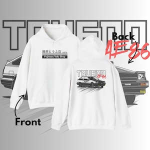 May include: White hoodie with a front graphic of Japanese text and the words "Fujiwara Tofu Shop". The back features a car graphic with the text "TRUENO AE86". The hoodie has a hood and a front pocket.