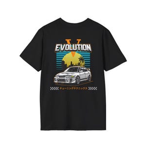 May include: Black t-shirt featuring a graphic of a white car with the word "EVOLUTION" above it. The design includes a sunset scene with palm trees and the Japanese text "チューニングテクニックス" at the bottom.