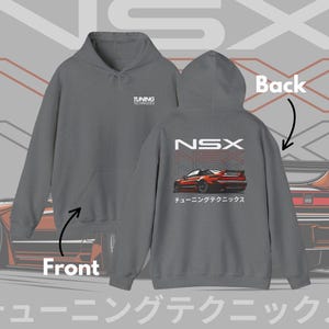 May include: Gray hoodie with a front pocket and hood. The back features a red car graphic with the text "NSX" and Japanese characters. The front has the text "TUNING TECHNIQUES".
