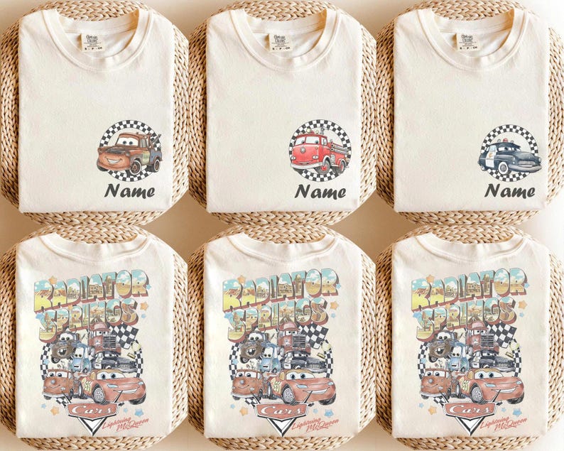 May include: Cream-colored t-shirts with various Cars movie graphics. Designs include Mater, a red fire truck, and a black and white police car, each within a checkered circle. The bottom shirts feature a larger design with multiple characters and the text "Radiator Springs".