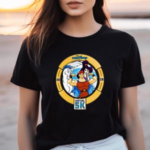 May include: Black t-shirt featuring a circular graphic with the text "runDisney" and "Virtual 5K." The graphic includes cartoon illustrations of Hercules, Megara, and Pegasus. The numbers "20" and "28" are on either side of the graphic.