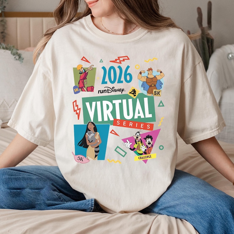 May include: Cream-colored t-shirt featuring the text "2026 runDisney VIRTUAL SERIES" with cartoon character graphics. The shirt includes images of Hercules, Pocahontas, and other Disney characters, with "5K" and "Challenge" labels.