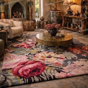 May include: A living room with a large rug featuring a floral design in pink and red hues. The room includes a round coffee table, a fireplace, and a decorative lamp. The style is rustic and welcoming.