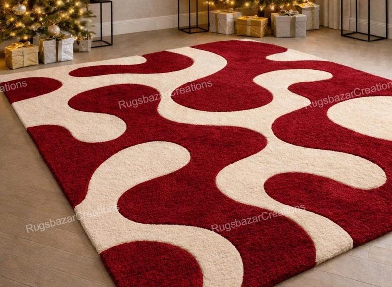 Puede incluir: Una alfombra rectangular con un dise&ntilde;o abstracto y audaz. La alfombra presenta un fondo rojo intenso con formas fluidas de color marfil. El dise&ntilde;o crea un contraste llamativo, adecuado para una sala de estar o dormitorio. Medidas en cent&iacute;metros.