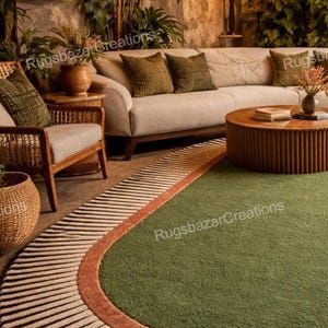May include: An oval-shaped area rug with a green center, bordered by a rust-colored band and a striped pattern of black and beige. The rug is in a living room setting with a sofa, chairs, and a coffee table.