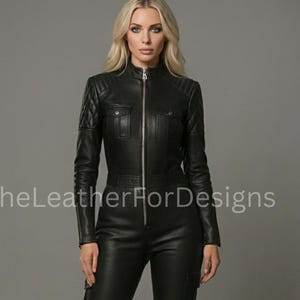 May include: Black leather jumpsuit with a zip-up front, quilted shoulder detailing, and cargo pockets. The jumpsuit has a high collar and is form-fitting. The text "TheLeatherForDesigns" is visible on the image.