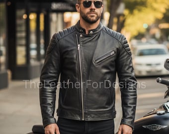May include: Black leather motorcycle jacket with a quilted shoulder design and an asymmetrical zipper. The jacket has a stand-up collar and a zippered chest pocket. The text "TheLeatherForDesigns" is visible on the jacket.