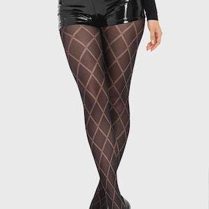 May include: Sheer black tights featuring a repeating diamond argyle pattern in a lighter shade of black. The tights are paired with high-waisted black vinyl shorts that have a glossy finish and a long-sleeved black top tucked into the waistband.