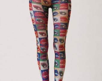 May include: High-waisted leggings featuring a repeating grid pattern of colorful human eyes and lips. The design includes various shades of red, blue, green, and yellow squares, each containing a detailed graphic of an eye or a pair of lips, covering the entire length of the fitted leg garment.
