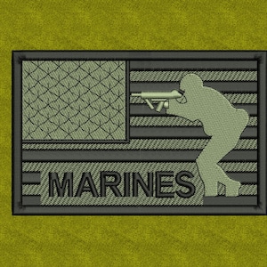 May include: Embroidered patch featuring a silhouette of a soldier aiming a weapon. The patch has a flag design on the left and the word "MARINES" at the bottom. The patch is in shades of green and black.