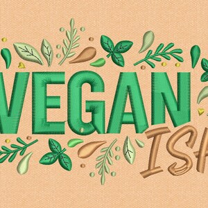 May include: Embroidered design with the word "VEGAN" in green, surrounded by green leaves and accents, and the word "ISH!" in a brown, stylized font, all on a peach-colored fabric background.