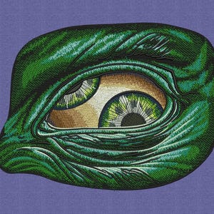 May include: Embroidered patch featuring a stylized eye with green and yellow iris, set against a green, textured background. The eye is set on a purple background. The patch has a detailed, textured appearance.