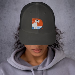 May include: Charcoal gray trucker hat with a white dog graphic inside an orange letter "D". The dog is wearing sunglasses and is in front of a blue and orange background. The hat has a mesh back.