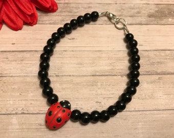 ladybug bracelet, ceramic ladybug bead, black glass beads, handmade, new