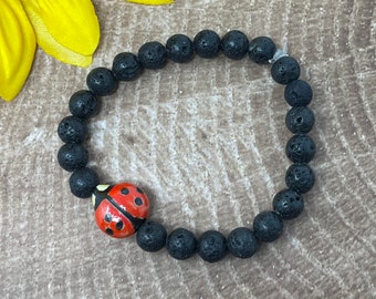 ladybug bracelet, ceramic ladybug and black lava rock beads, handmade, new