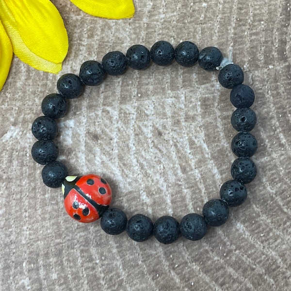 ladybug bracelet, ceramic ladybug and black lava rock beads, handmade, new