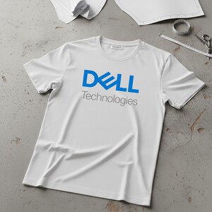 May include: White t-shirt with the blue "DELL Technologies" logo. The short-sleeved shirt is made of a soft material and is laying on a gray surface. Sewing tools and patterns are in the background.
