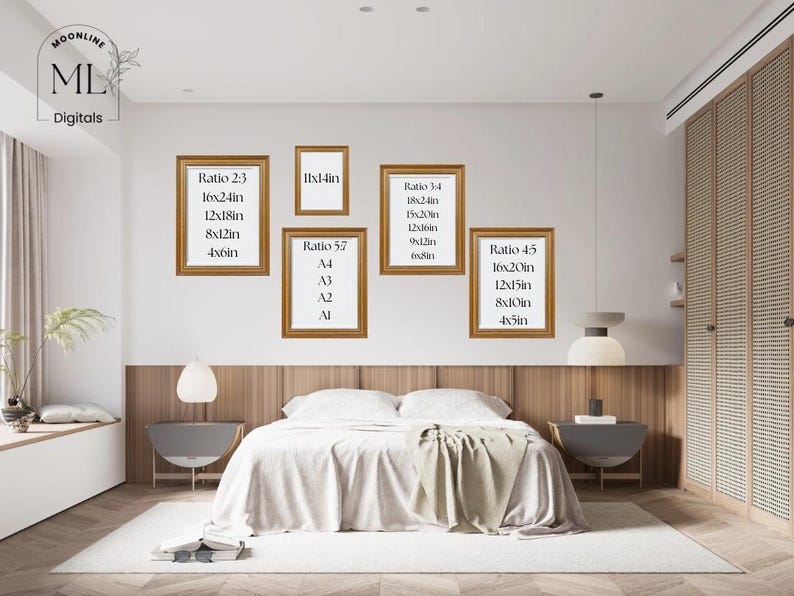 May include: A bedroom interior featuring a bed with a white comforter, a rug, and framed art prints on the wall. The frames are gold-colored, and the prints display size ratios and dimensions in inches. The room has a modern design with neutral tones.