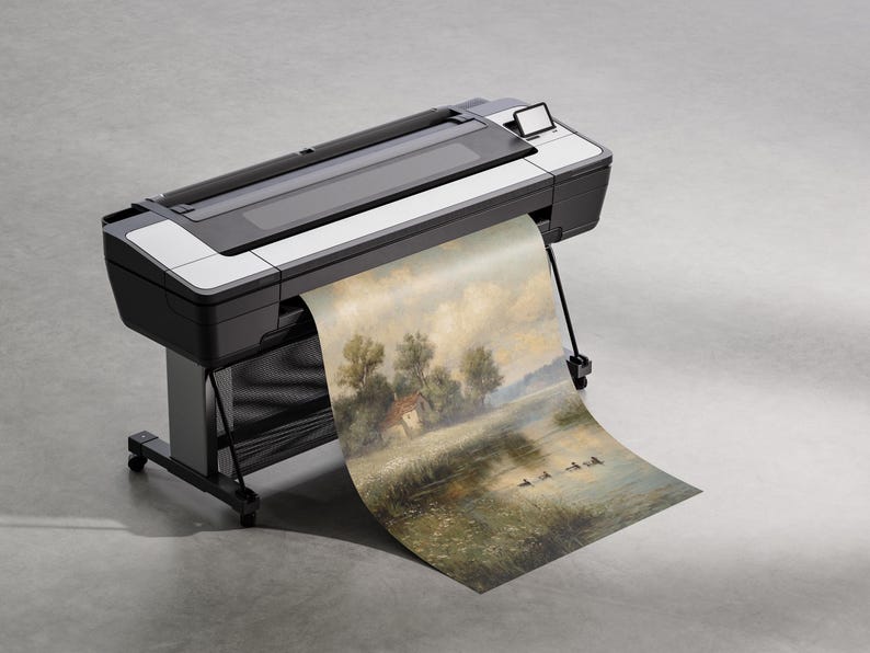 May include: A large format printer in black and white is shown printing a landscape painting. The painting depicts a serene scene with trees, a small house, and a body of water. The printer is on a stand with wheels.