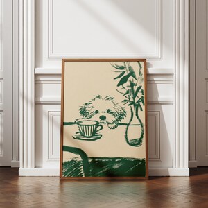 May include: A framed art print featuring a green and beige illustration. The artwork depicts a dog looking at a teacup and saucer on a table, with a vase of plants. The frame is a warm brown color.