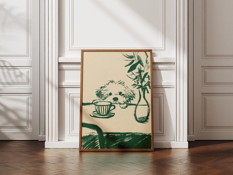 May include: A framed art print featuring a green and beige illustration. The artwork depicts a dog looking at a teacup and saucer on a table, with a vase of plants. The frame is a warm brown color.