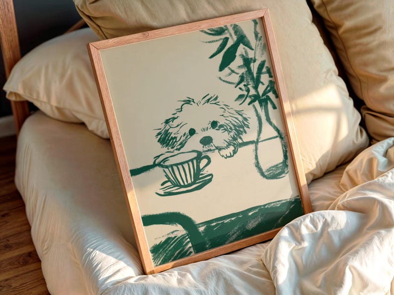 May include: A framed print featuring a green illustration of a dog peering over a table with a teacup. The artwork has a minimalist style, with a light beige background and a wooden frame. The dog is drawn in a loose, sketchy style.