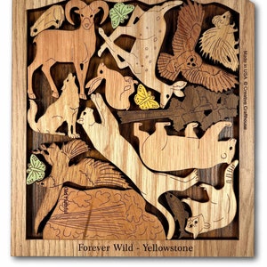 May include: Wooden jigsaw puzzle featuring a variety of animals native to Yellowstone National Park, including a bear, wolf, deer, and a bighorn sheep. The puzzle is made of different wood tones and includes the text "Forever Wild - Yellowstone" and "Old Faithful".