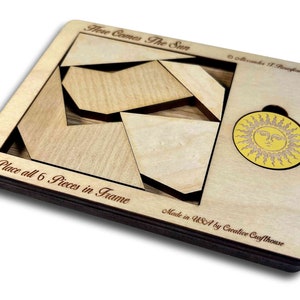Here Comes the Sun wooden brain teaser puzzle - a fun but challenging puzzle! Can you fit the sun into the large square frame along with all of the other pieces? Great for a desk, coffee table or waiting room. Made in USA by Creative Crafthouse.