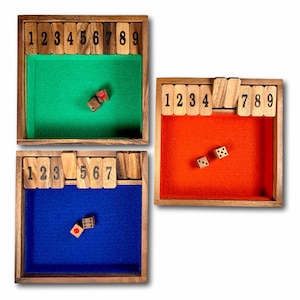 May include: Three wooden game boards with numbered tiles and dice. The boards are green, orange, and blue. The tiles are numbered 1 through 9. The dice are wooden and have black dots.