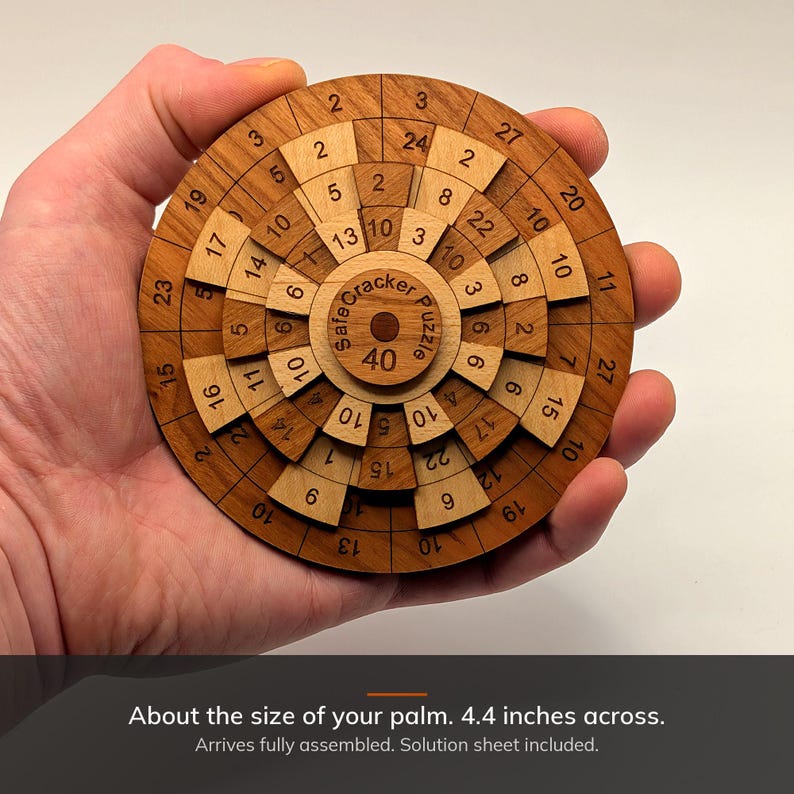 Safecracker 40 wooden math puzzle held in a hand, about 4.4 inches across, Creative Crafthouse