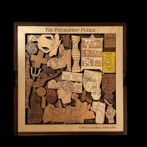 May include: A wooden puzzle with the title "The Psychiatrist Puzzle" and various images of mental health concepts, including a brain, a psychiatrist, a DNA strand, and a book. The puzzle is made by Creative Craftshouse and is made in the USA.