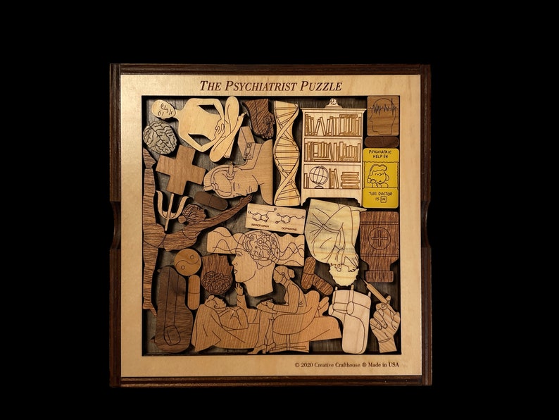 May include: A wooden puzzle with the title "The Psychiatrist Puzzle" and various images of mental health concepts, including a brain, a psychiatrist, a DNA strand, and a book. The puzzle is made by Creative Craftshouse and is made in the USA.