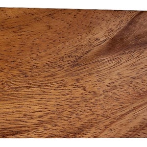 May include: A rectangular wooden box with a natural wood grain finish. The box has a light brown color and a smooth surface.