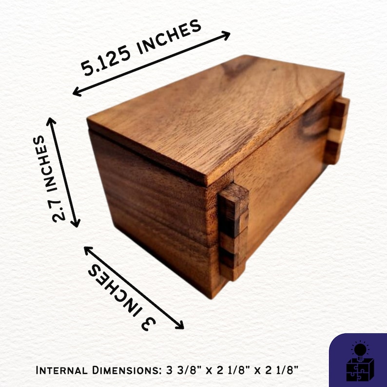 May include: A wooden box with a sliding lid and intricate joinery. The box measures 5.125 inches long, 2.7 inches tall, and 3 inches wide. The internal dimensions are 3 3/8 inches by 2 1/8 inches by 2 1/8 inches.