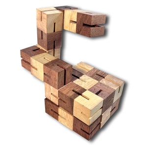 May include: A wooden puzzle made of small, interlocking cubes. The puzzle is in the shape of a letter 'S' and is made of light and dark wood.