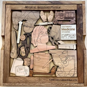 May include: A wooden jigsaw puzzle with a medical theme. The puzzle pieces include a stethoscope, a blood pressure cuff, a thermometer, a syringe, a bandage, a clipboard, a medical textbook, and a doctor wearing a face mask. The puzzle is made by Creative Crafthouse and is made in the USA.