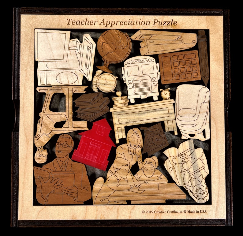 May include: A wooden teacher appreciation puzzle with a schoolhouse, a bus, a computer, a clock, books, a desk, a chair, and a teacher with students. The puzzle is made by Creative Craft House and is made in the USA.